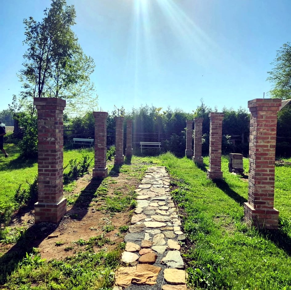 Brick columns lining a stone walkway