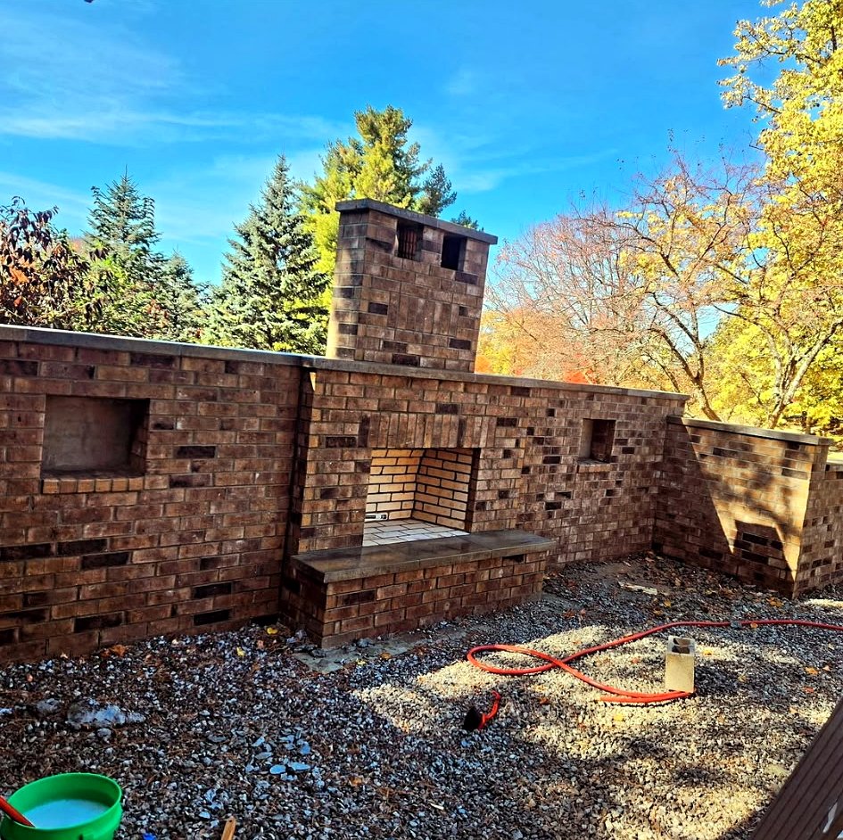 Outdoor brick fireplace and surrounding wall